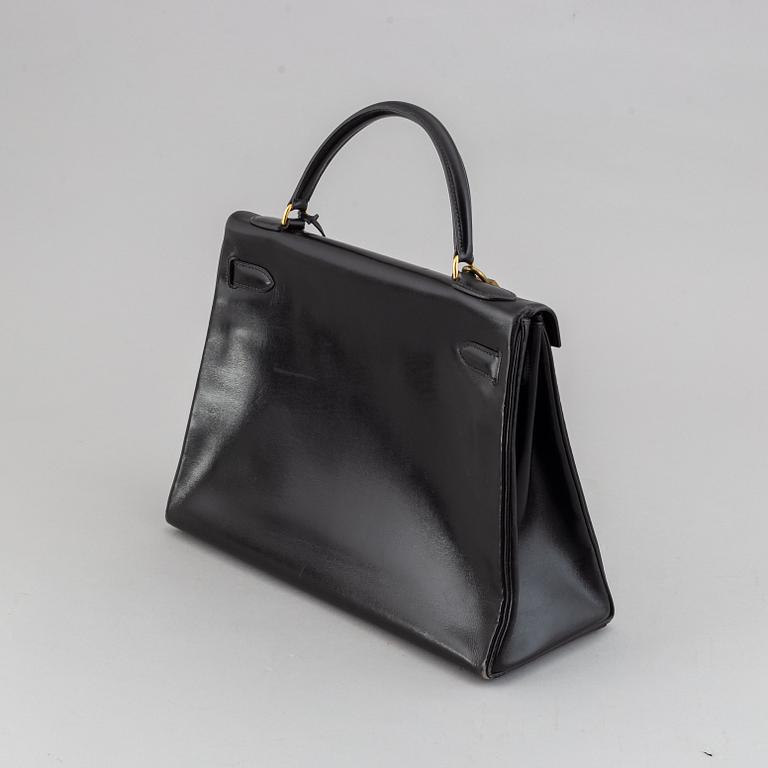 Hermès,a black leather 'Kelly 32' handbag, 1975.