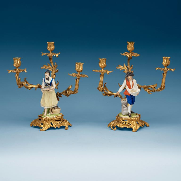 A pair of bronze candelabra with porcelain figures, French/English, second half of 19th Century.