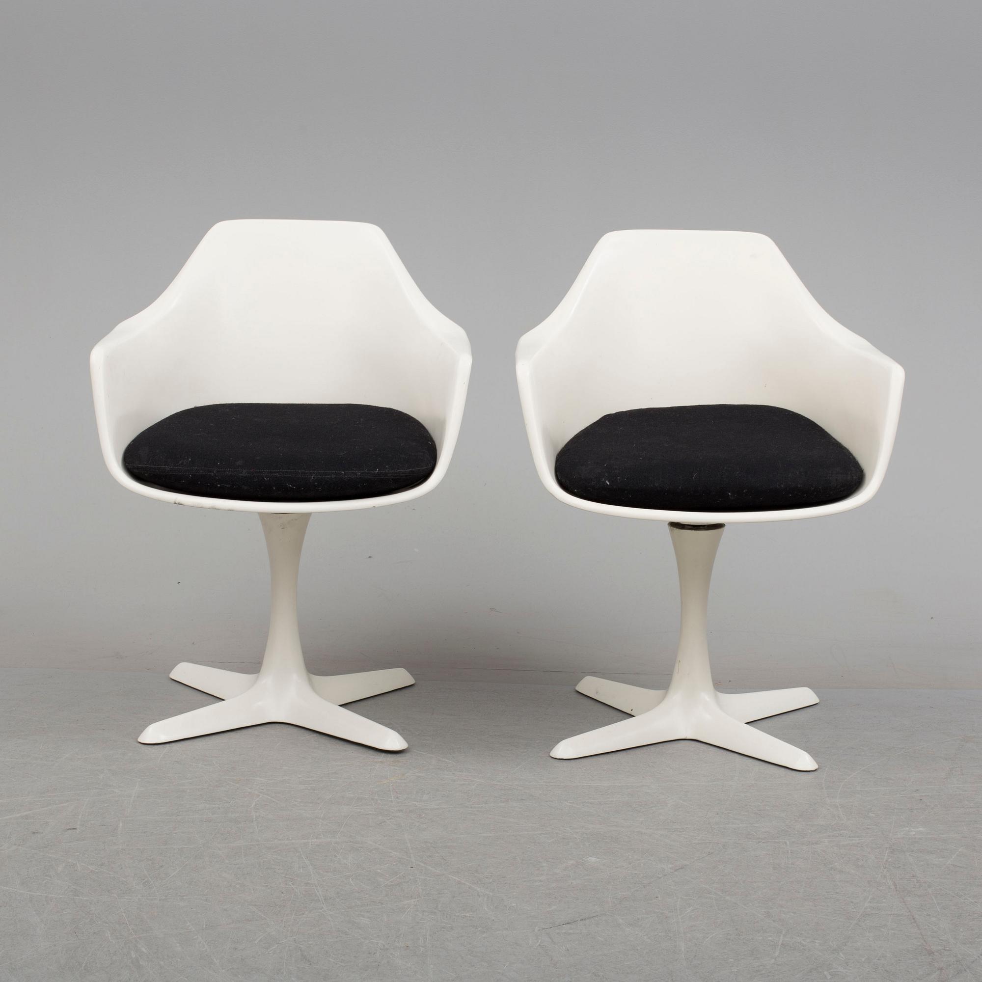 A dining table and eight chairs by Robin Day, Arkana.