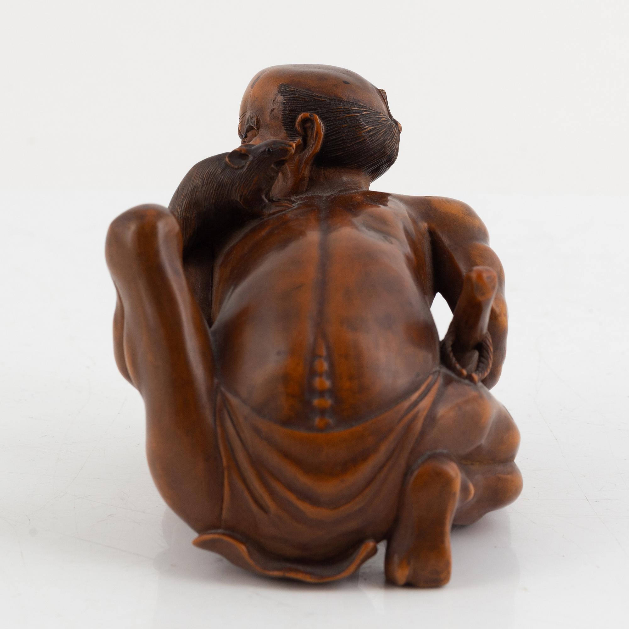 A Japanese mei boxwood okimono of a rat catcher. Meiji period.