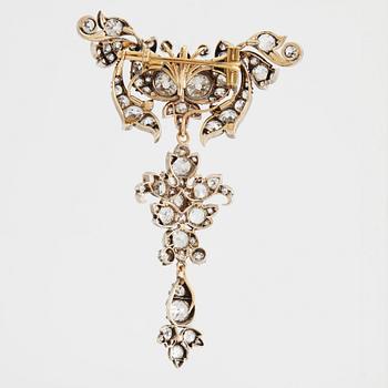 A 14K gold and silver brooch set with old-cut diamonds.