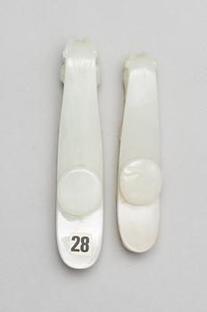 Two pale green nephrite garment hooks, Qing dynasty.