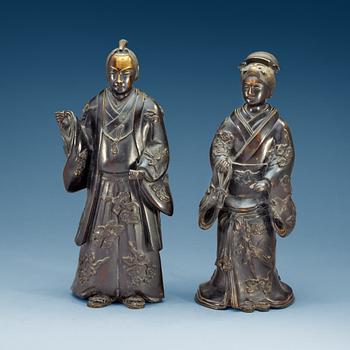 1881. Two standing Japanese bronze sculptures of a Samurai and elegant lady, 18/19th Century.