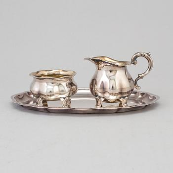 A parcel-gilt rococo style creamer, sugarbowl an a tray from Wilkens, Germany.