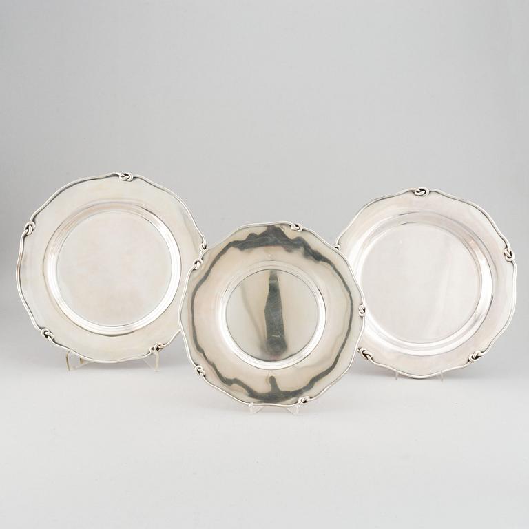 Three silver serving plates, decorated with "knots", Swedish import marks.
