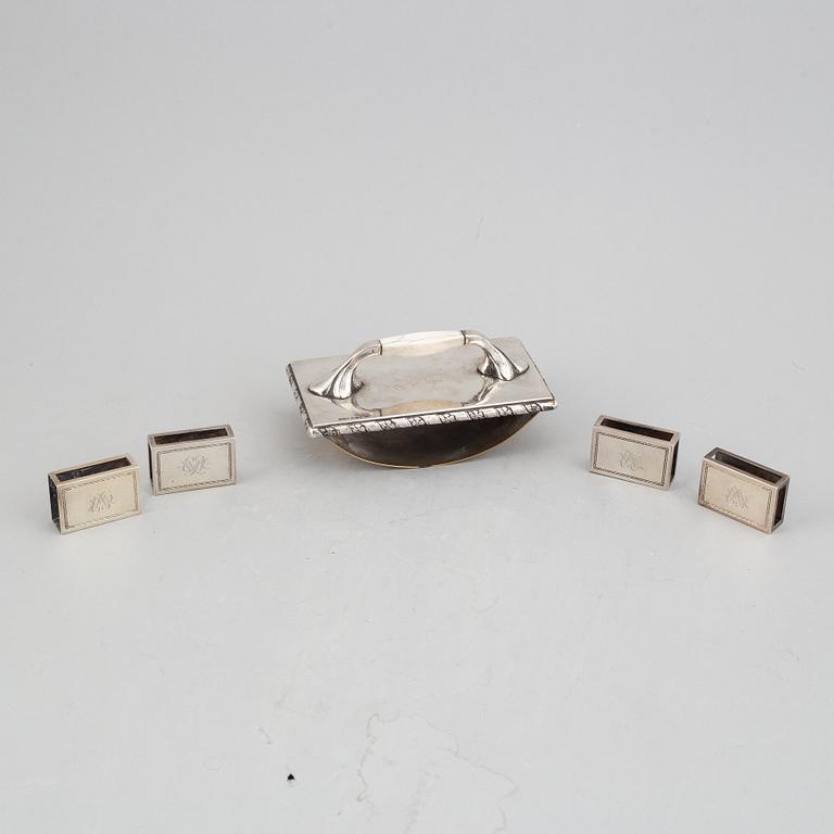 Atelier Borgila, 4 tändsticksfodral samt läskpappersvagga, silver, Stockholm 1922 samt 1939.