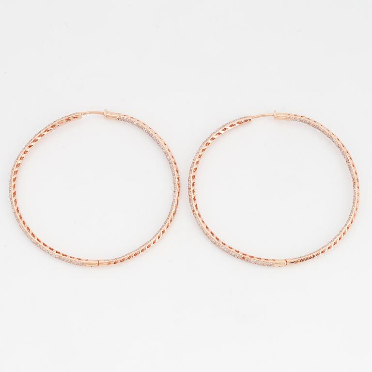 Rose gold and diamond hoop earrings.