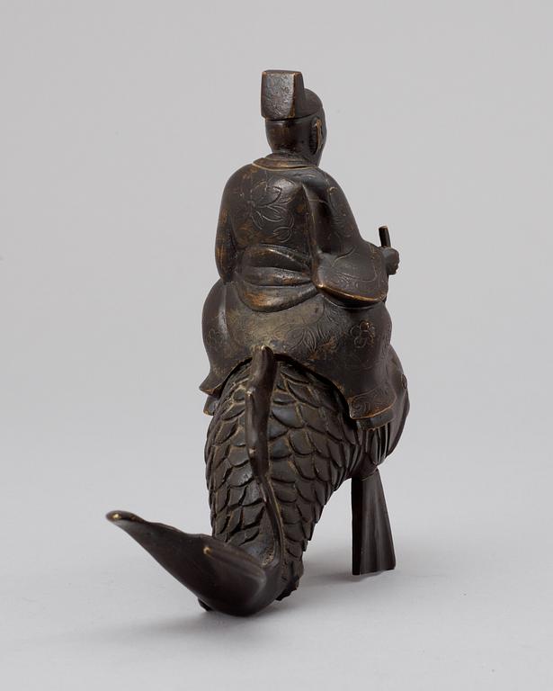 A Japanese Meiji bronze figure, Kinko on a carp.