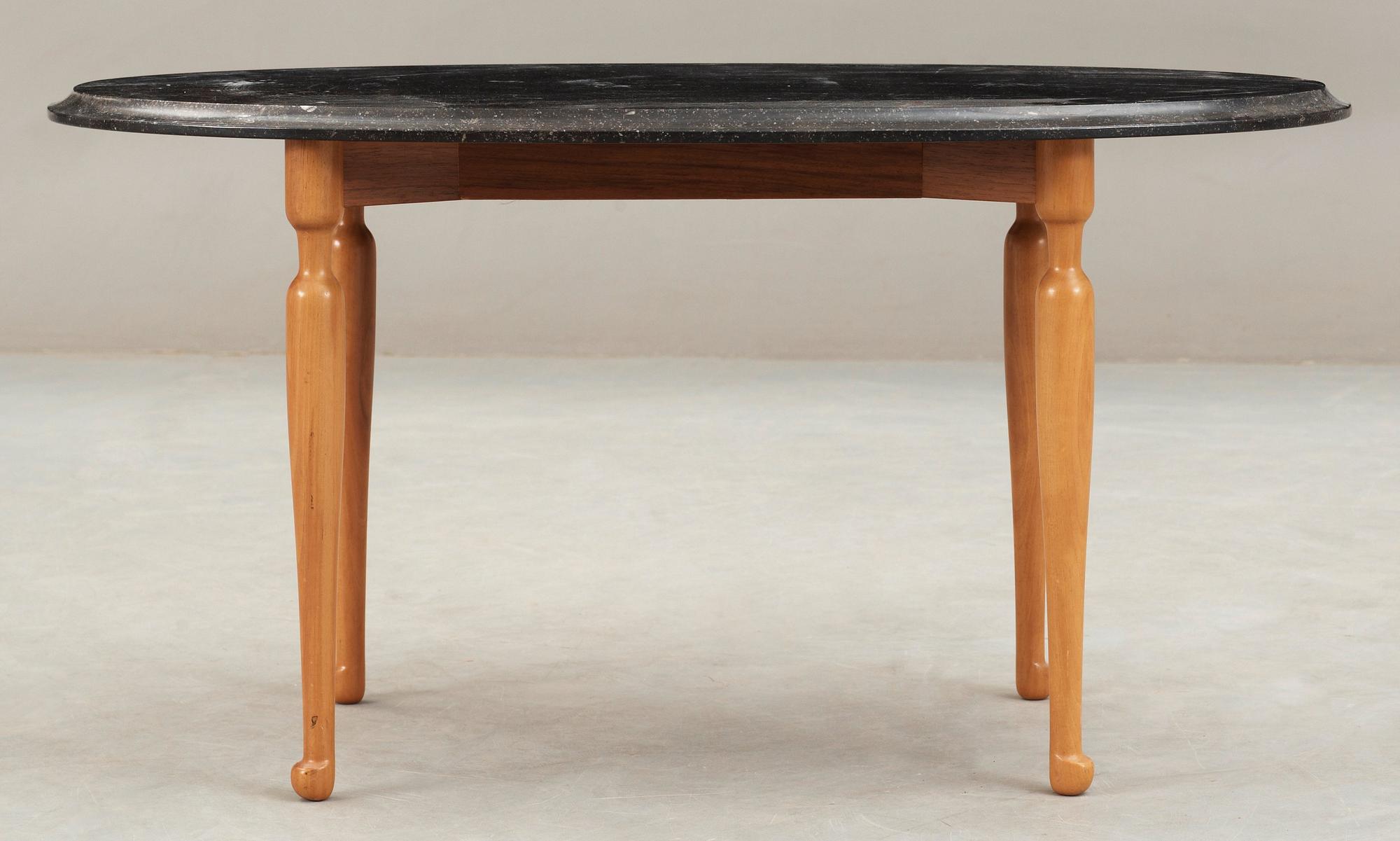 A Josef Frank black marble top table on a mahogany and walnut base, Svenskt Tenn, Sweden.
