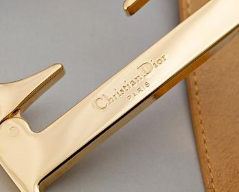 A beige leather belt by Christian Dior.