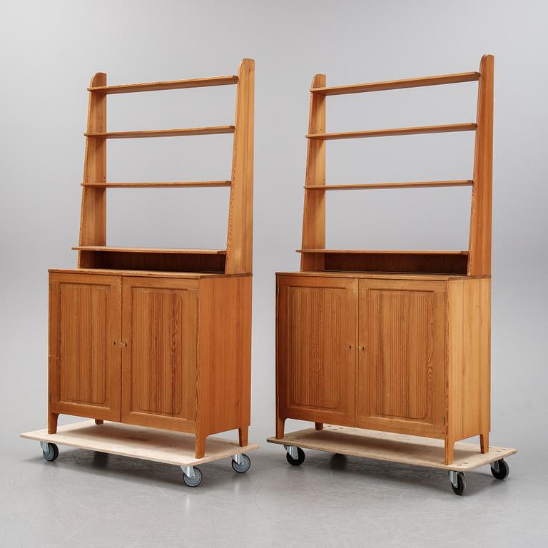 A pair of pine cupboards with shelves by Carl Malmsten.