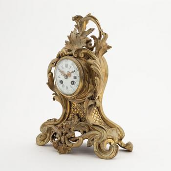 A circa 1900 brass rococo-style mantle clock.