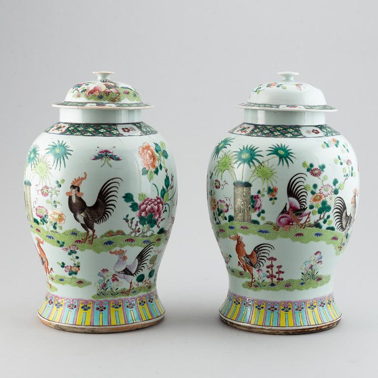 A pair of large Chinese famille rose baluster jars with covers, 20th century.