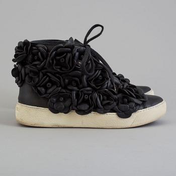 A black leather sneakers by Chanel.