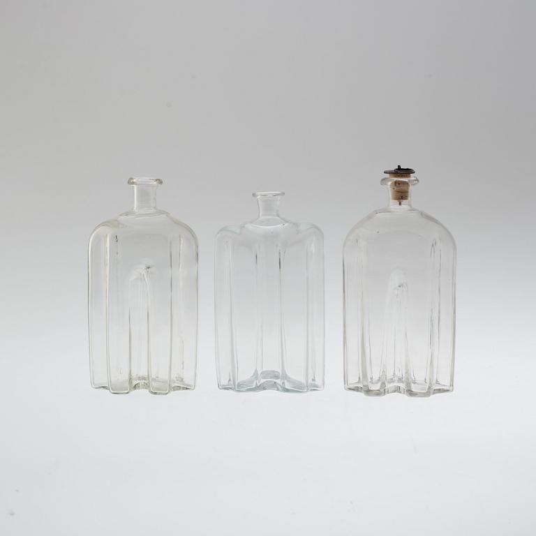 A set of three glass bottles, 19th century.