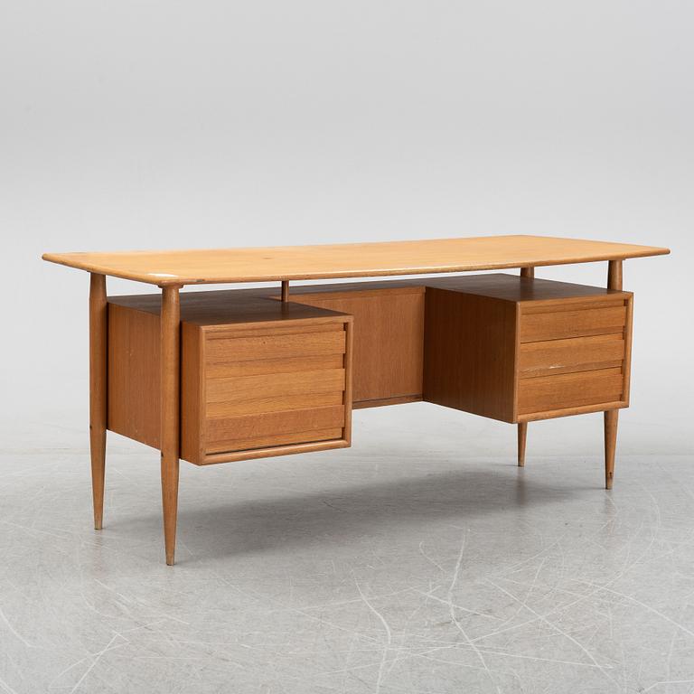 A teak veneered writing desk, 1950's/60's.