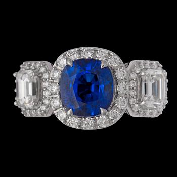 1390. A cushion cut blue sapphire 3.06 cts, and emerald-and brilliant cut diamond ring.