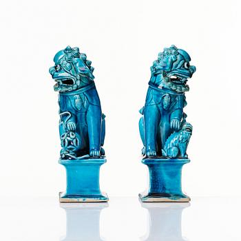 A pair of Chinese turquoise glazed buddhist lions, Qing dynasty, 18th Century.