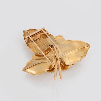 BROSCH med en cabochonslipad smaragd samt diamanter.