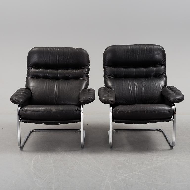 A pair of leather upholstered easy chairs from Dux, late 20th Century.