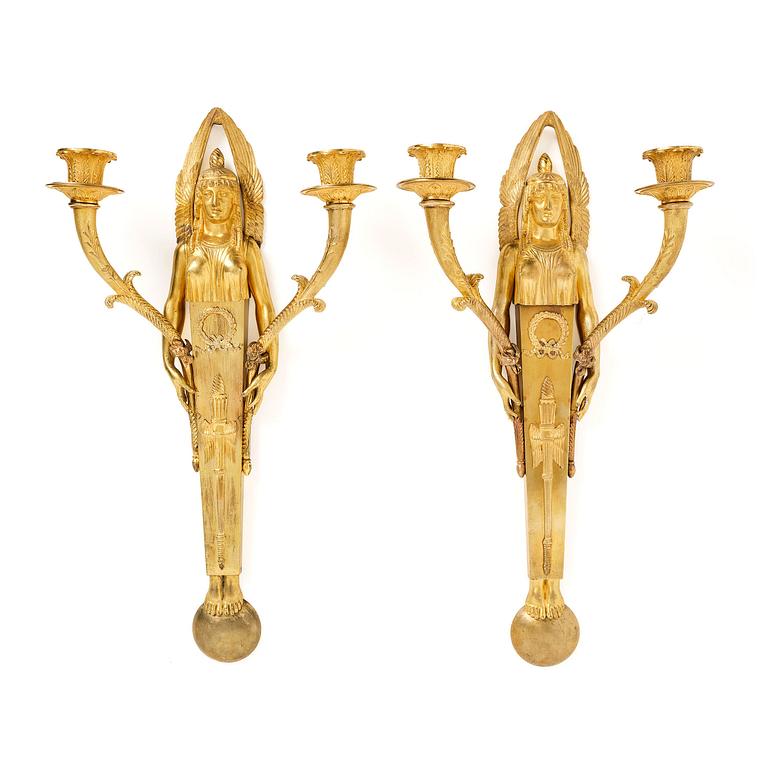 A pair of French Empire two-branch ormolu wall lights, early 19th century,.