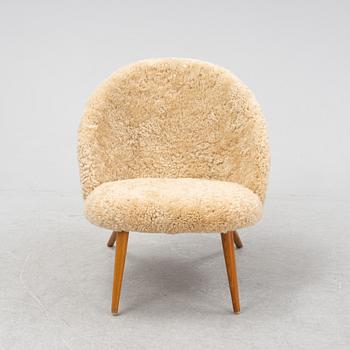 A shearling upholstered Swedish Modern easy chair, 1950s.
