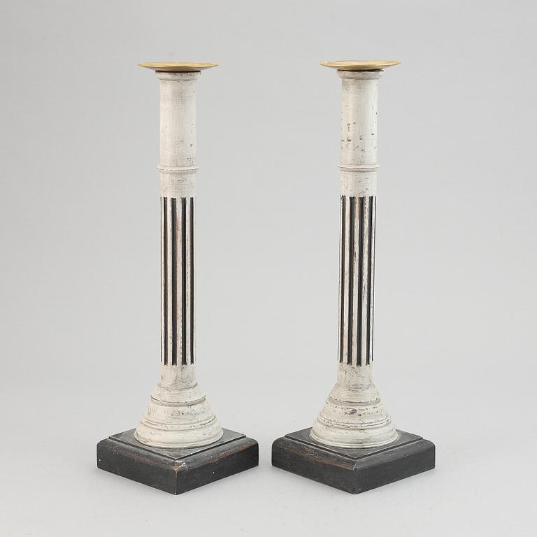 A pair of 20th century wooden candle holders.