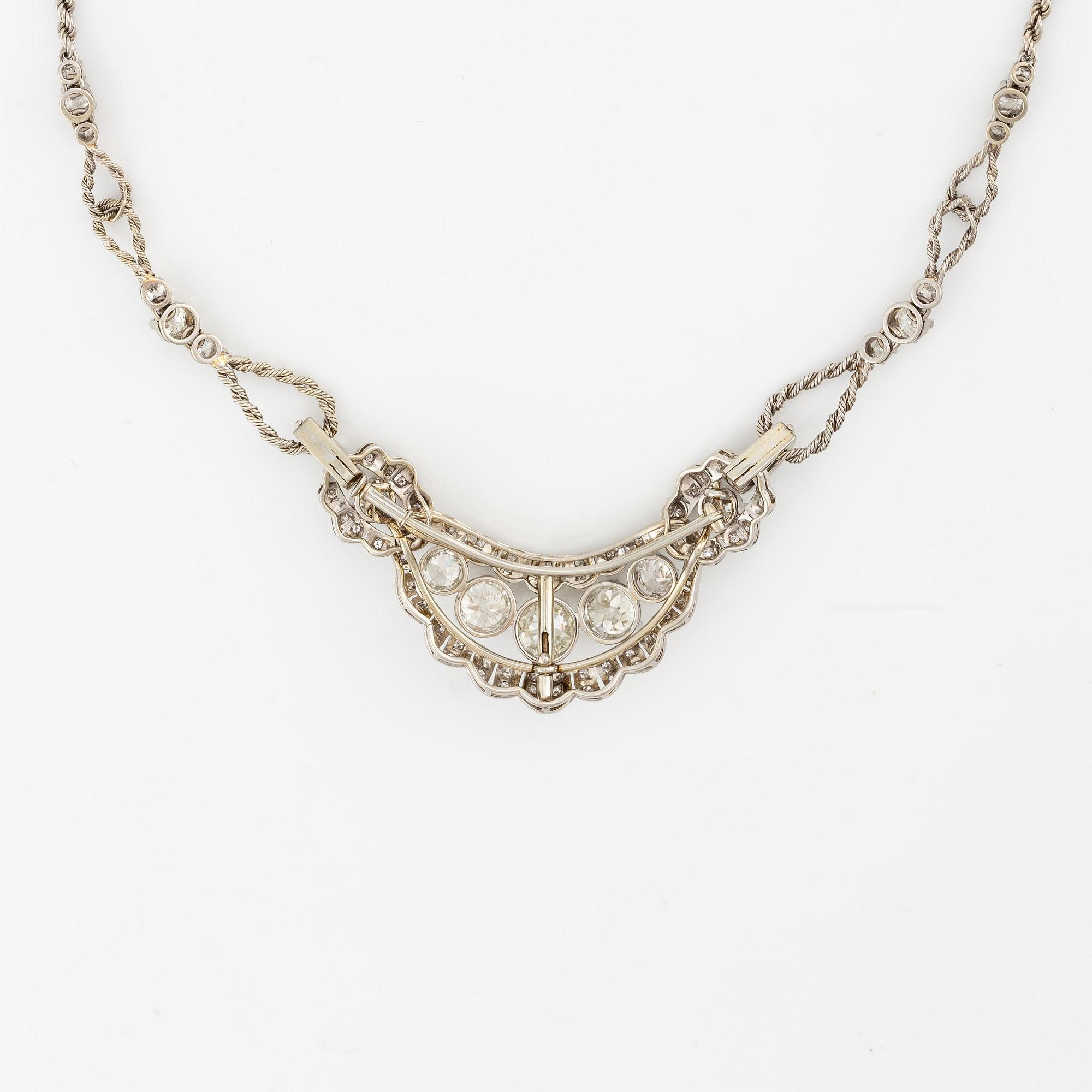 A brooch/necklace combination in 18K white gold set with old- and eight-cut diamonds.