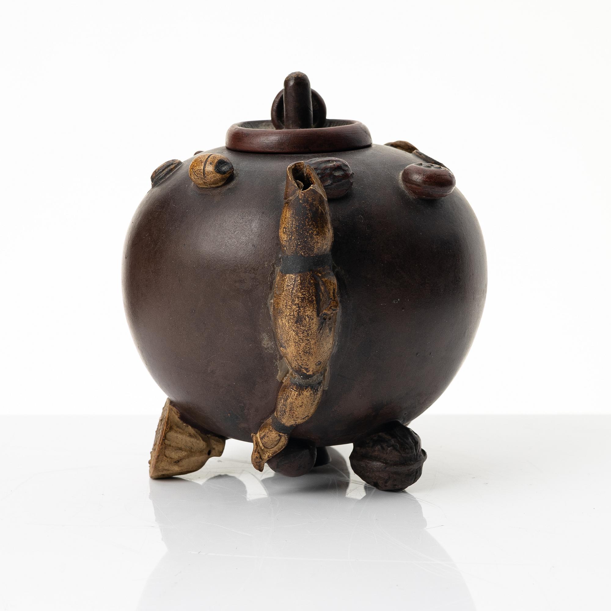 A Chinese 'hundred-fruit' yixing teapot, Qing dynasty (1644-1912).