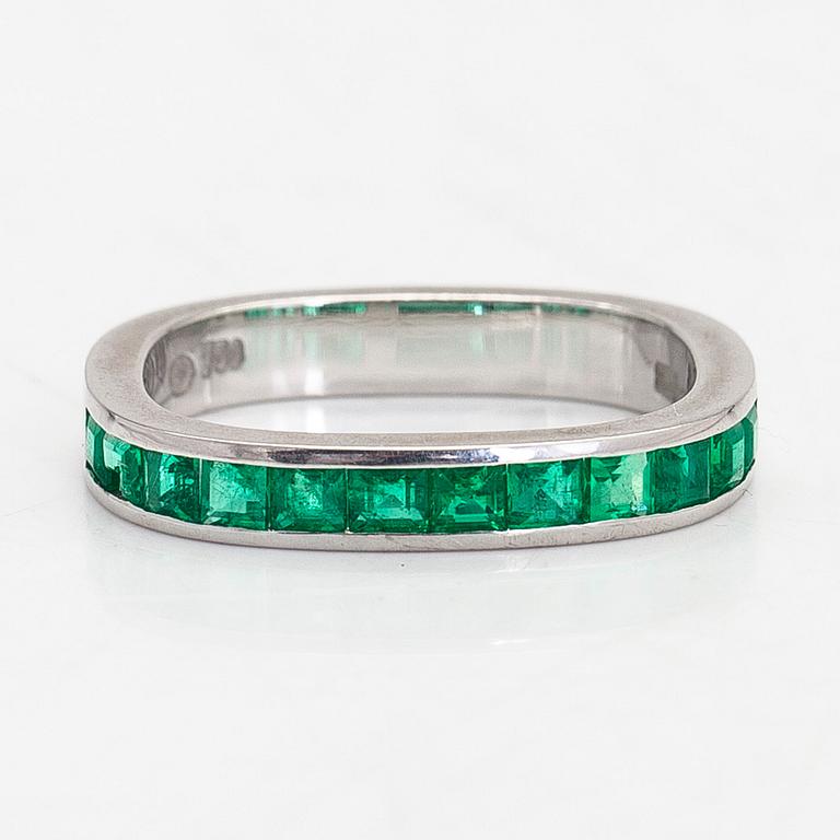 An 18K white gold eternity ring, with square-cut emeralds, Switzerland.