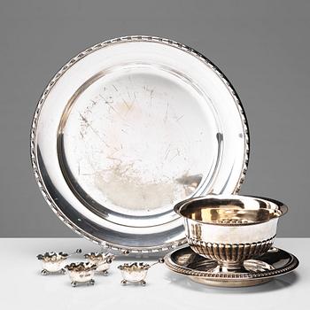 16. A set of four English silver salt-cellars and sauce-bowl and a dish plated metal.