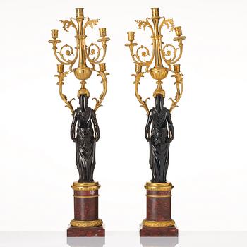 A pair of Louis XVI ormolu and patinated bronze six-branch candelabra attributed to François Rémond, late 18th century.