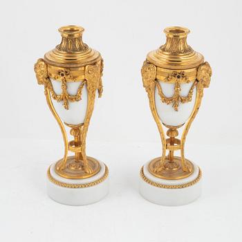 A pair of French Louis XVI-style ormolu and marble cassolettes, later part of the 19th century.