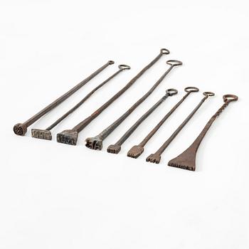 A set of eight wrought-iron brands, 18th century.