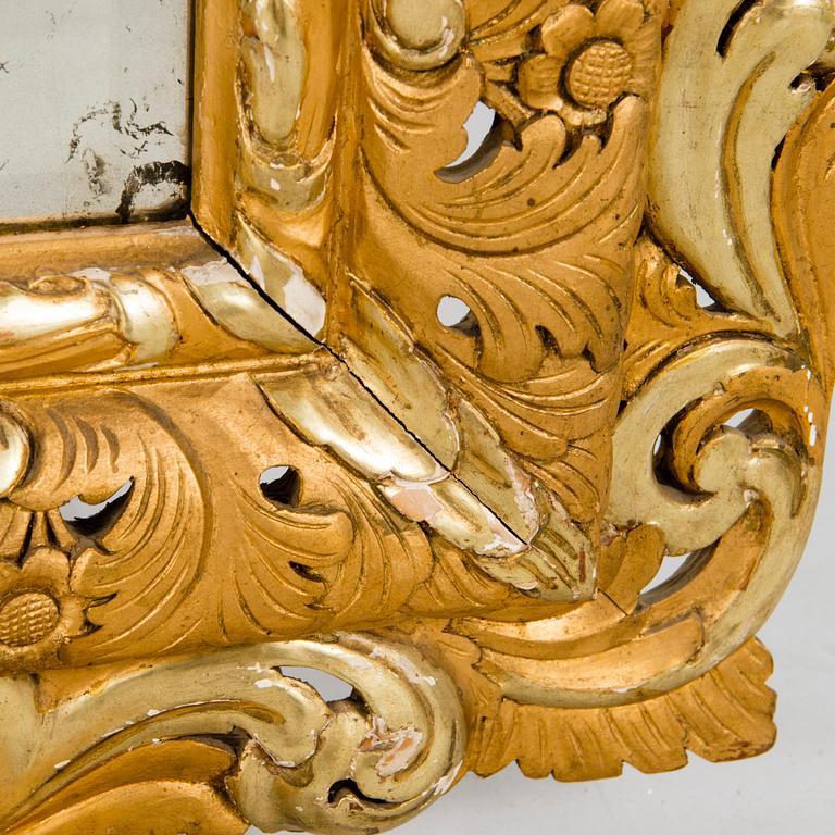 A MIRROR, Baroque style, circa 1900, gilt wood.