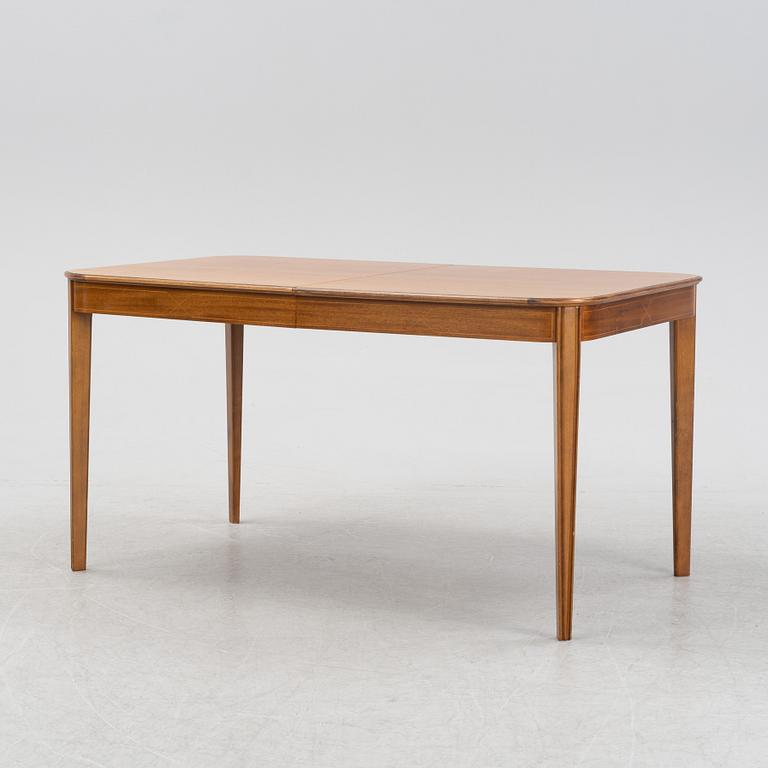 A 1950's/60's mahogany and mahogany veneered dining table.