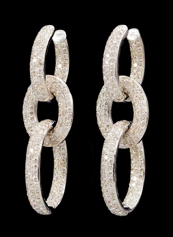 A pair of gold and diamond earrings.