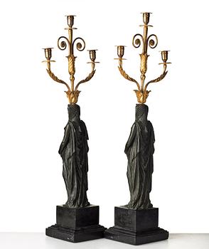 A pair of French Empire early 19th century three-light candelabra.