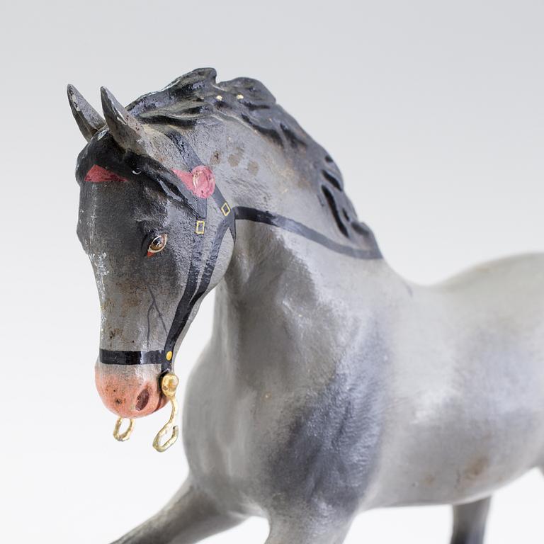 A painted tinplate toy horse ca year 1900.