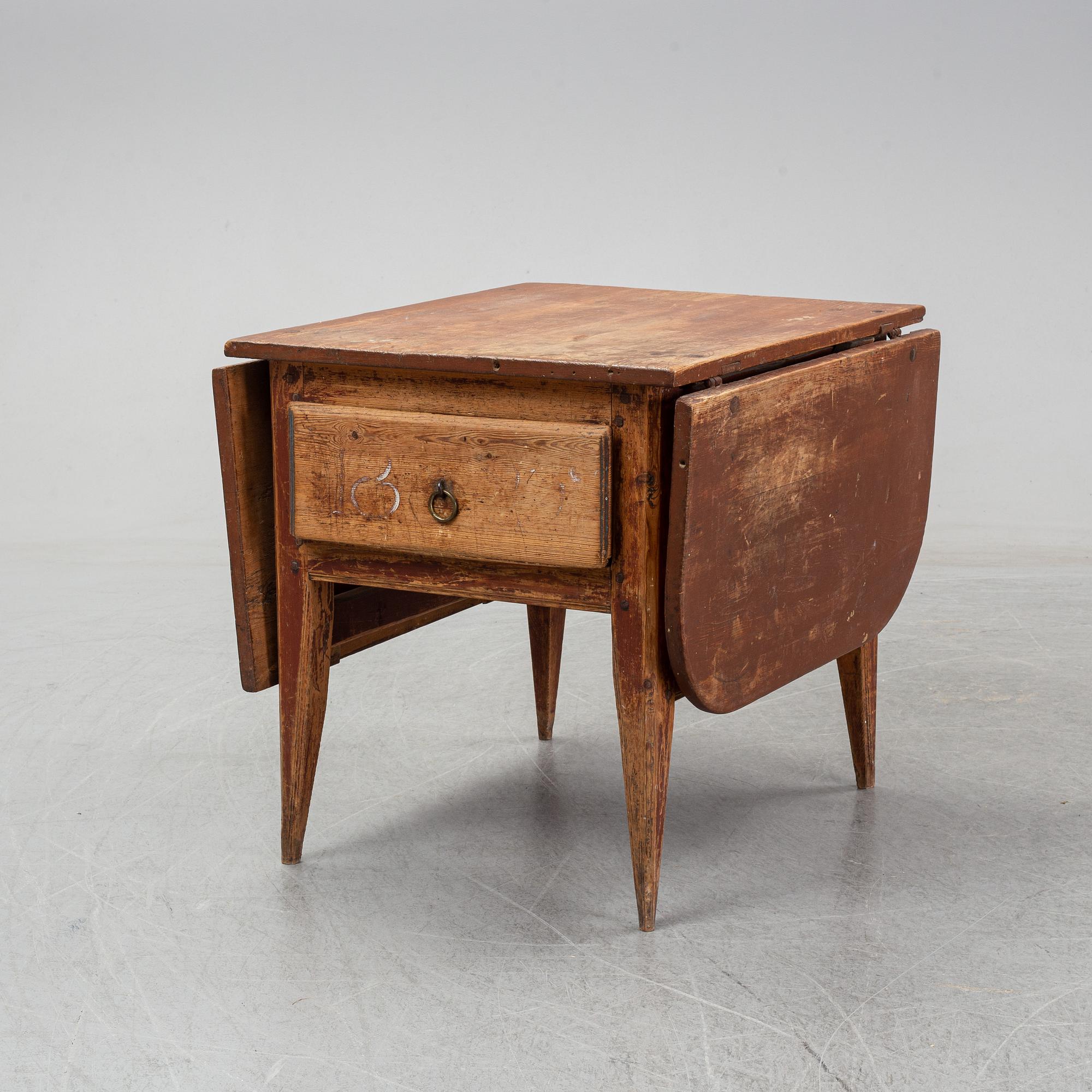 A 19th Century table with drop leaves.