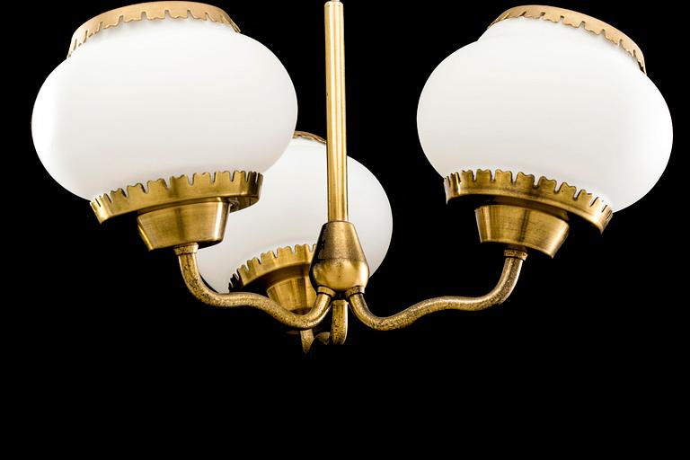 BEN KARLBY FOR LYFA, a brass and white glass ceiling lamp, second half of 20th century.