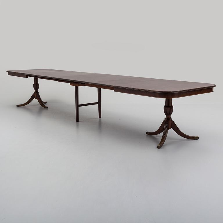 A second half of the 20th century mahogany  dining table with 5 additional leaves.