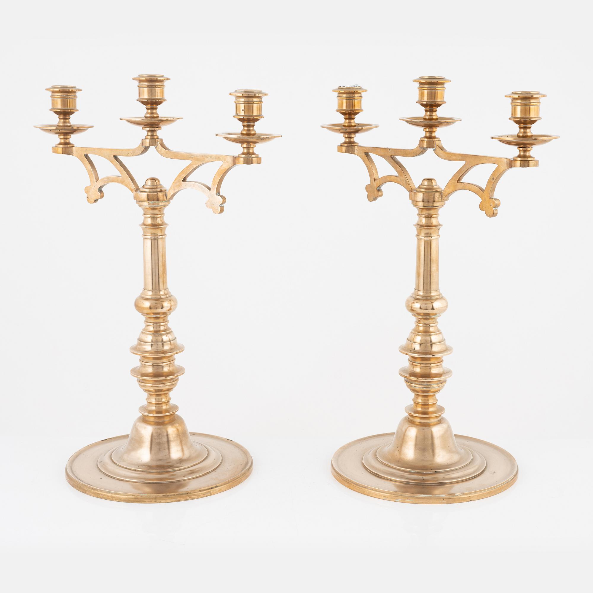 A pair of brass candelabra, early 20th Century.