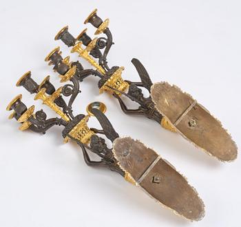 A pair of French Empire five-branch gilt and patinated bronze appliques, first part 19th century.