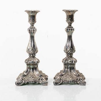 A pair of rococo-style silver candle sticks, early 20th century.