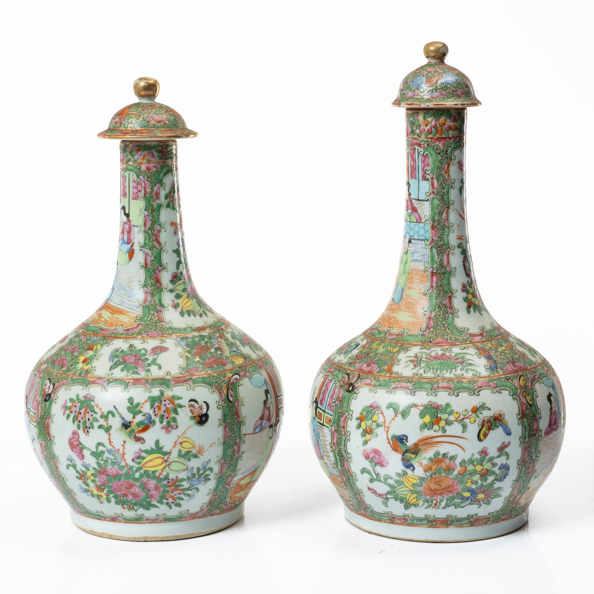 Two famille rose 'Canton' vases with covers, Qing dynasty, 19th century.