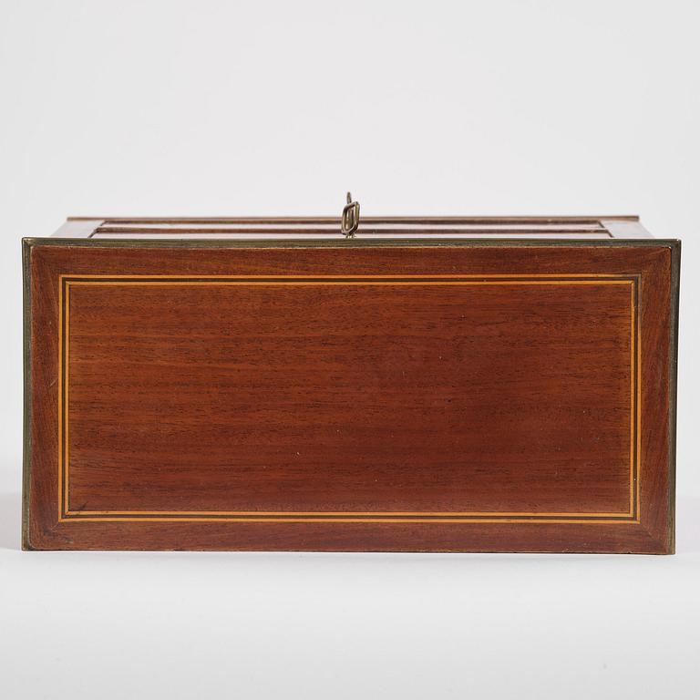 A Northern European mahogany miniature commode, early 19th century.