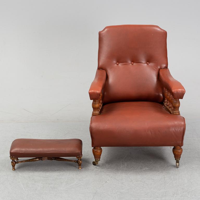 A late empire armchair with stool, mid 19th century.
