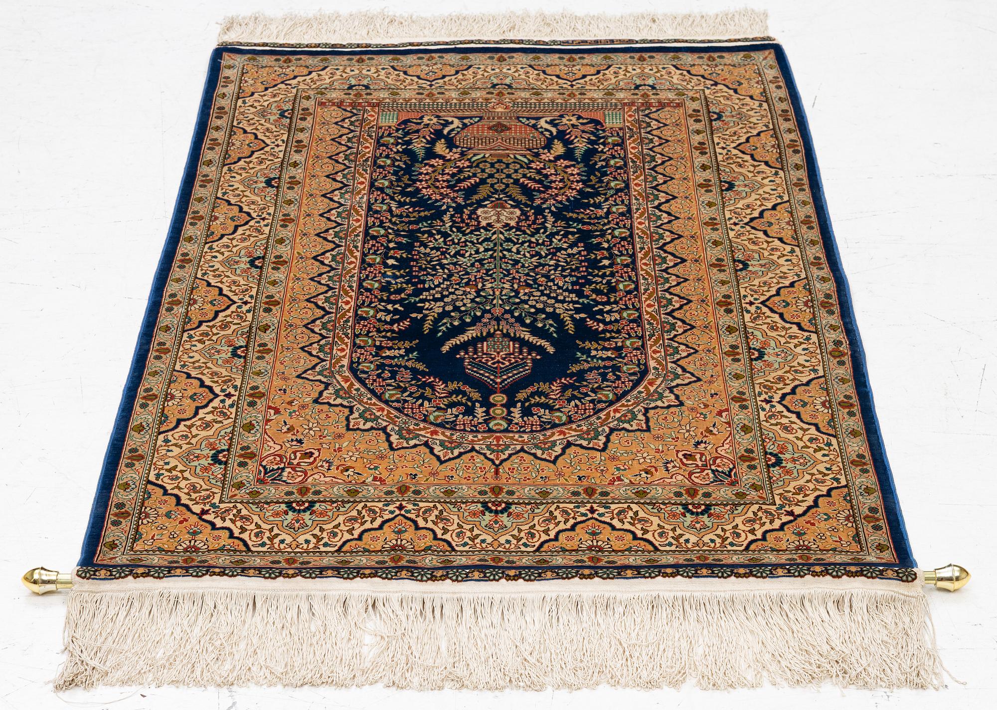 A semi-antique silk Hereke rug, West Anatolia, signed c. 107 x 72 cm.