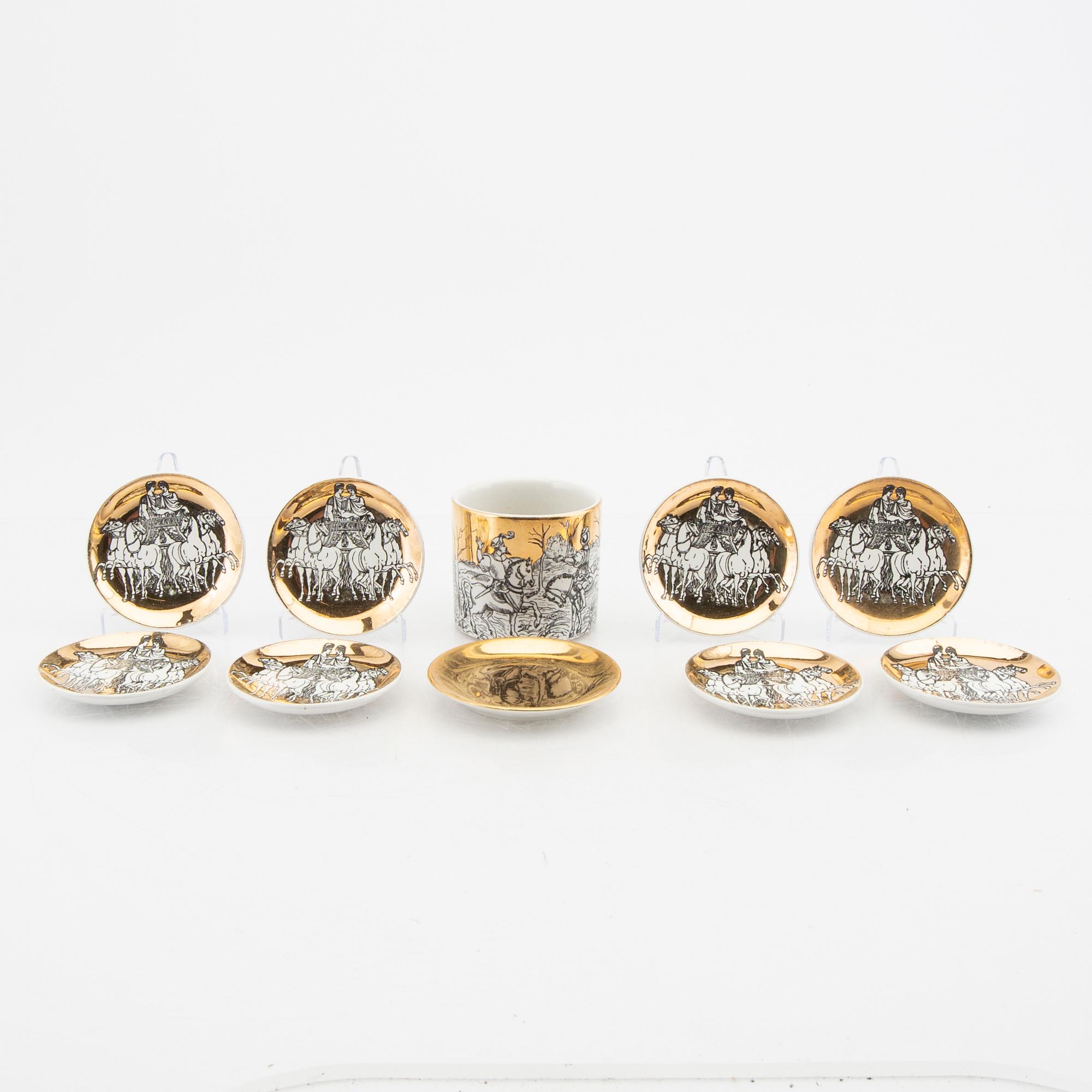 Piero Fornasetti, a set of eight small plates and a mug Italy mid 1900s.
